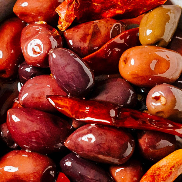Close-up of marinated olives with a glossy texture