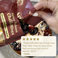 Hand holding a package of spicy Sichuan chilli olives with a five-star rating and review from Helen.