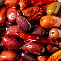 Close-up of marinated olives with a glossy texture