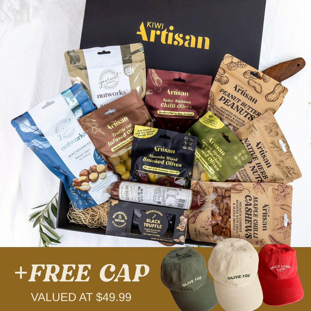 Kiwi Artisan gift box with various snacks and a promotional banner for free caps.