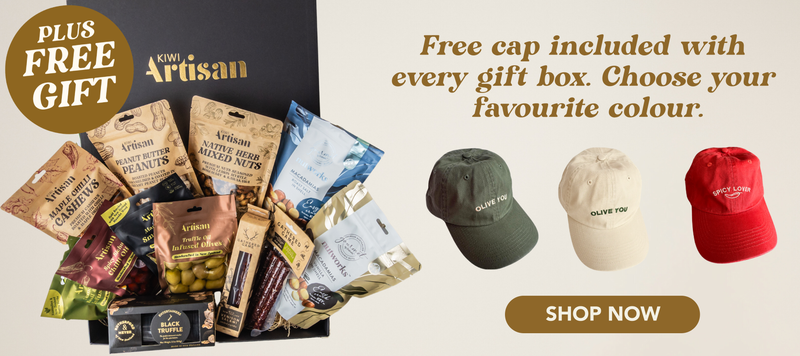 Gift box with Artisan products and three caps displayed, with text about a free cap offer.