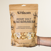 Bag of Kiwi Artisan Roast Salt Macadamias on a beige background
